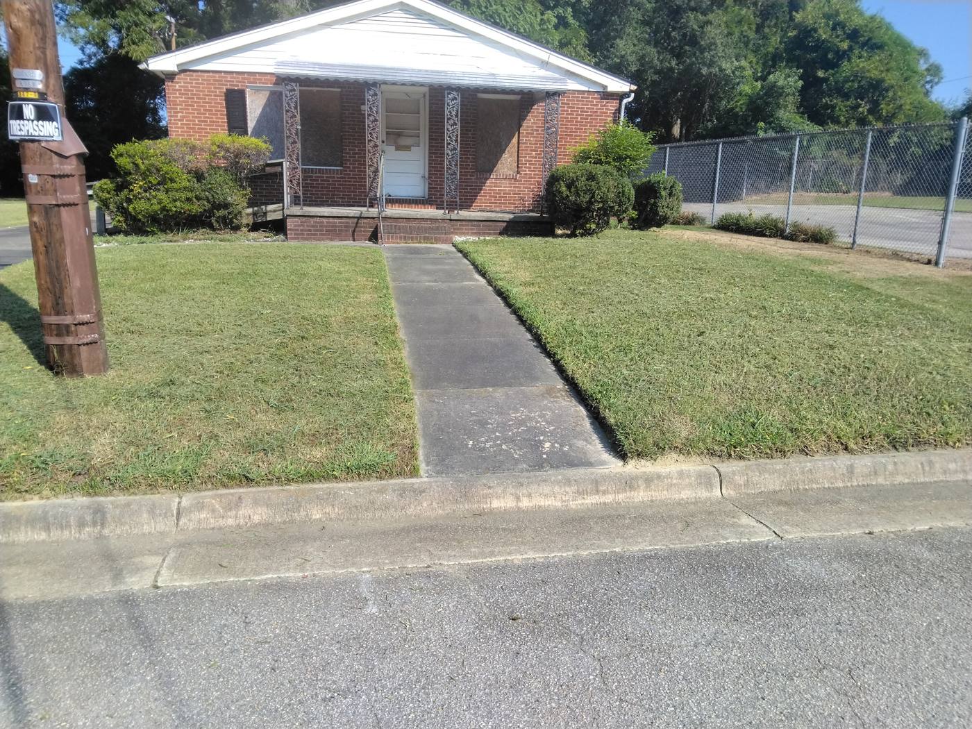 Crew member mowing a residential lawn